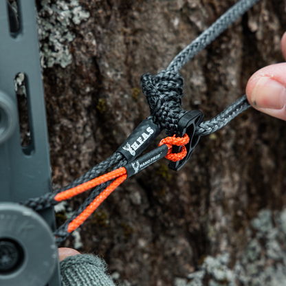 Close up of 1/8 Full Bury Hang Free® Attachment System Being used to attach stick to the tree.