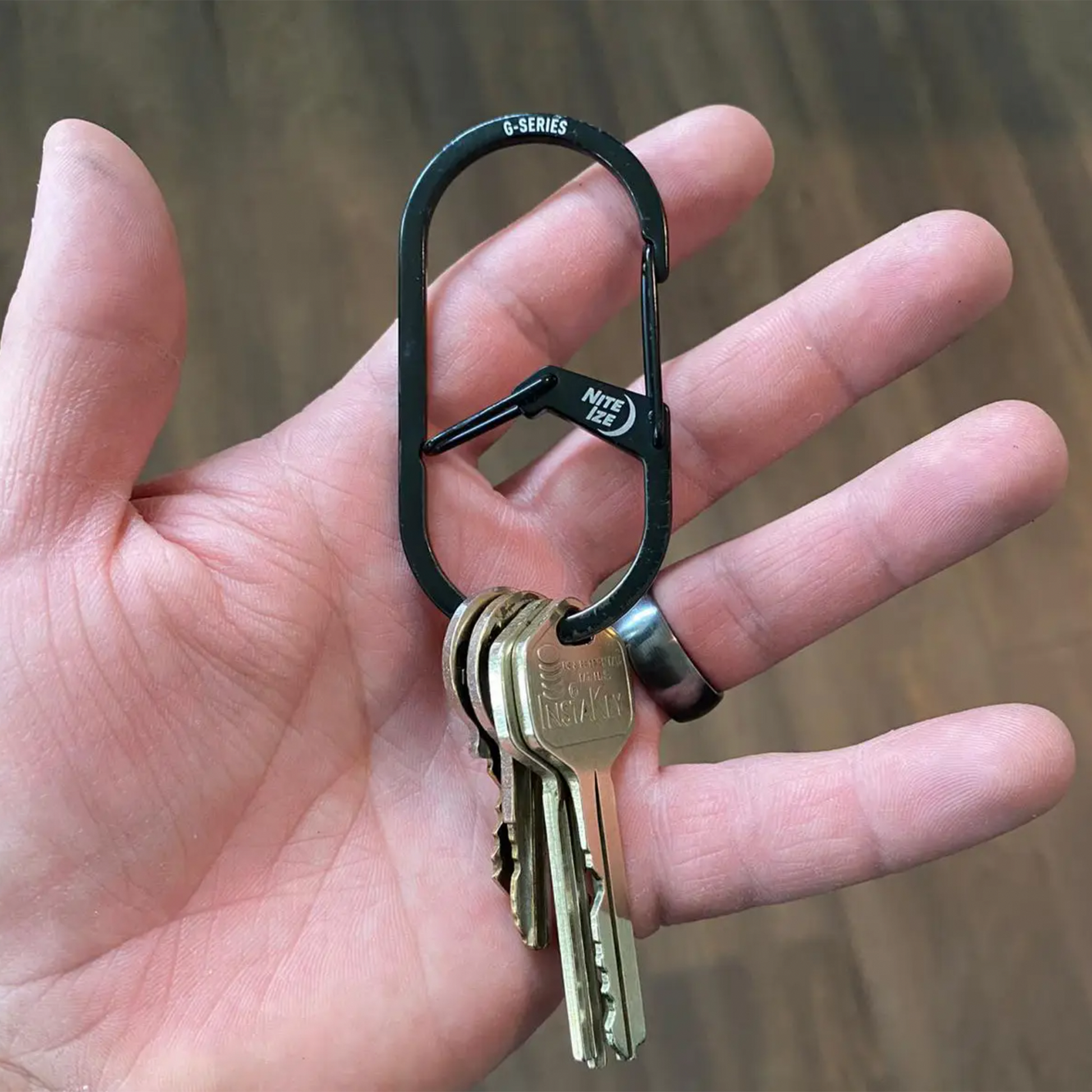 G-Series Dual Chamber Carabiner #3 Black With keys on it in a hand