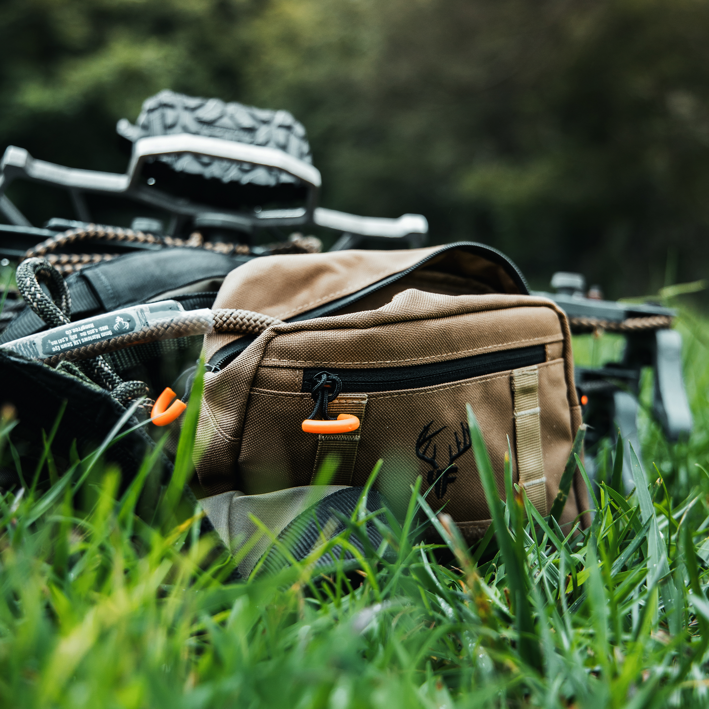 'SideKick' Saddle Bag In Use On saddle on the ground with rope coming out of the main pocket.