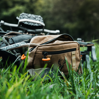 'SideKick' Saddle Bag In Use On saddle on the ground with rope coming out of the main pocket.